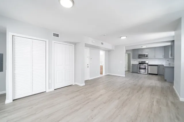 a view of kitchen and hall with wooden floor