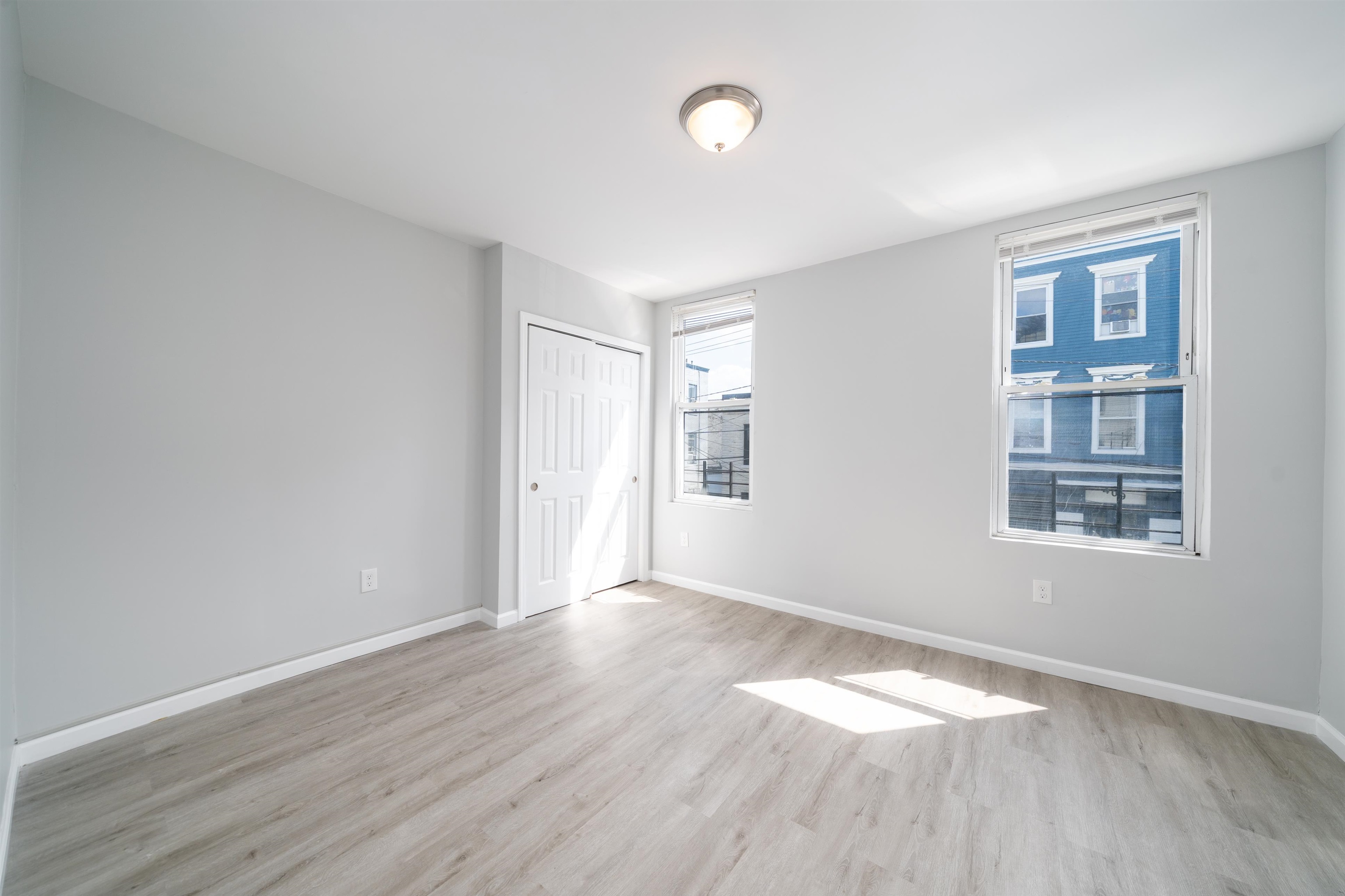 408 Monastery Place, Unit 2 Union City, NJ 07087 - Photo 10 of 21 wooden floor in an empty room with a window