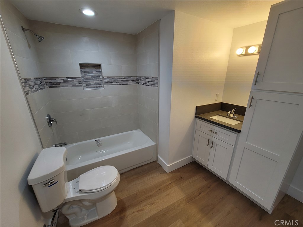 13564 4th Street, Unit 2 Yucaipa, CA 92399 - Photo 6 of 7 a bathroom with a toilet a sink and bathtub