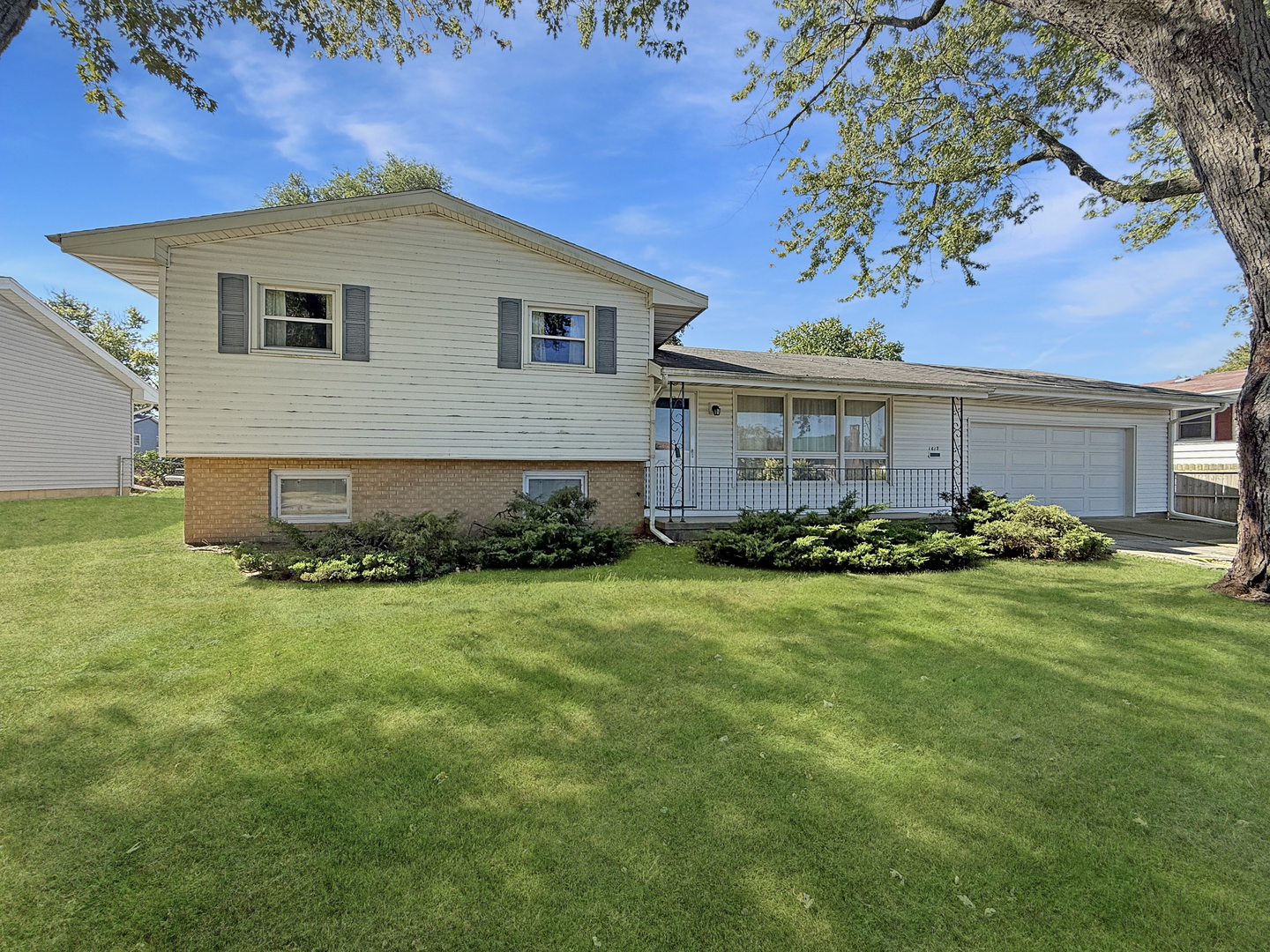 1612 Carolina Drive Rantoul, IL 61866 - Photo 1 of 18 a front view of a house with garden