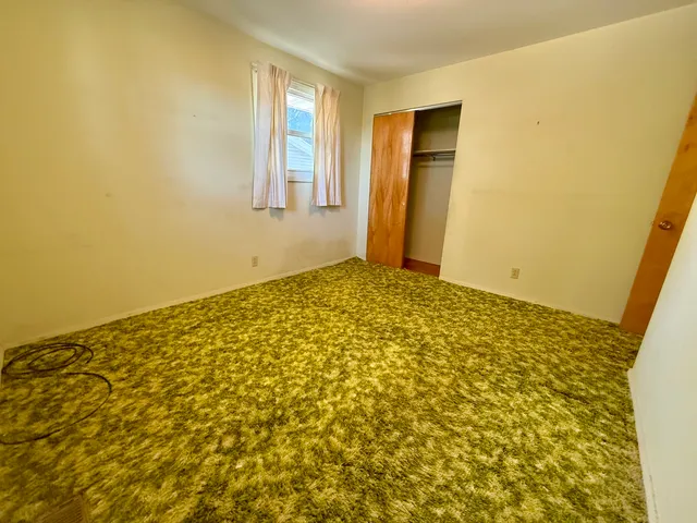 a spacious bathroom with a granite countertop sink a toilet and shower