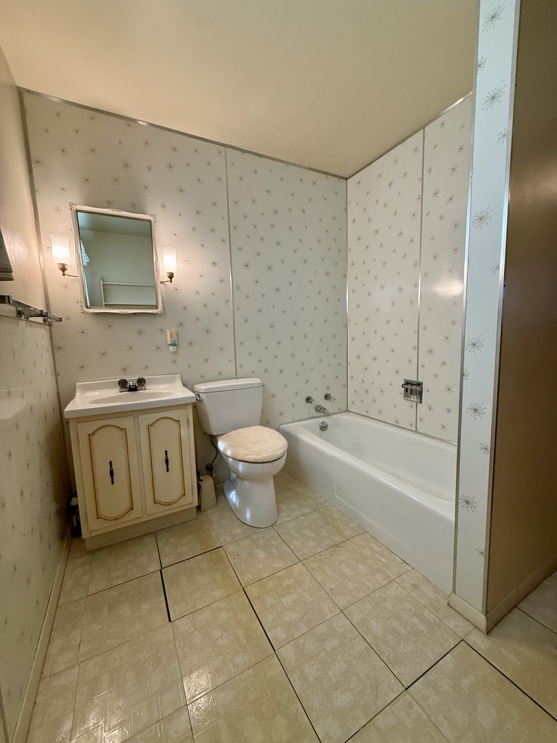 1612 Carolina Drive Rantoul, IL 61866 - Photo 12 of 18 a spacious bathroom with a granite countertop sink a toilet and shower