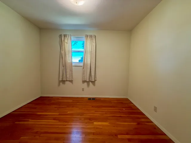 a view of an empty room with closet