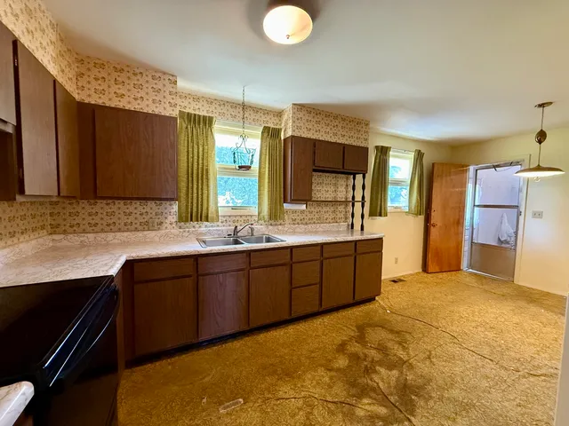 a spacious bathroom with a granite countertop sink and a mirror