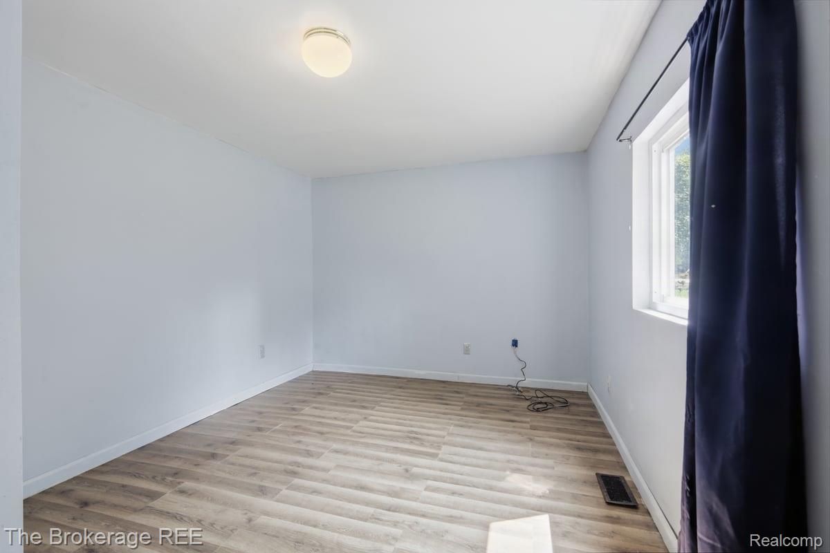 10135 Clark Road Davison, MI 48423 - Photo 27 of 38 Wood-finish flooring, light-toned walls, and a single window with a white frame