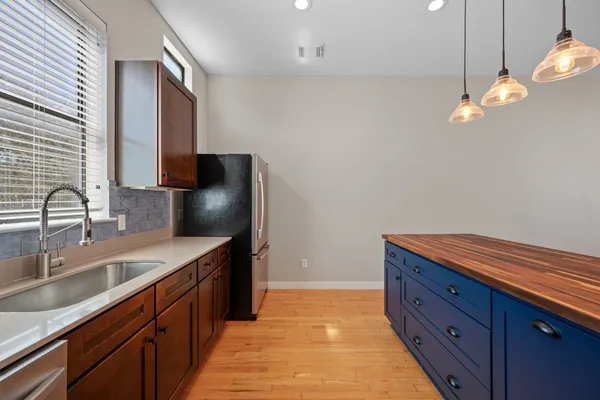 a kitchen with a sink stove and microwave