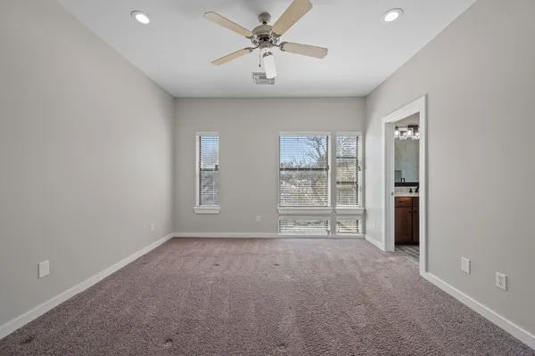 a bathroom with a granite countertop sink a toilet and a mirror