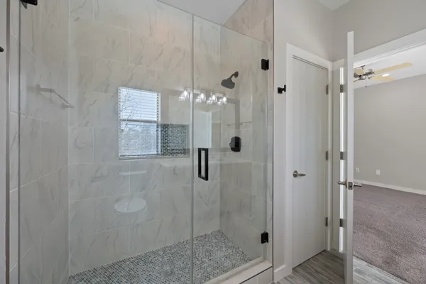 a bathroom with a granite countertop sink toilet and shower