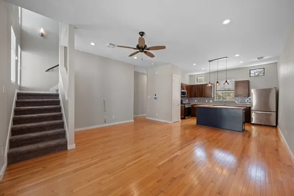 a view of kitchen with wooden floor and electronic appliances