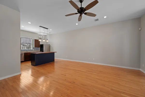 a view of workspace with wooden floor and ceiling fan