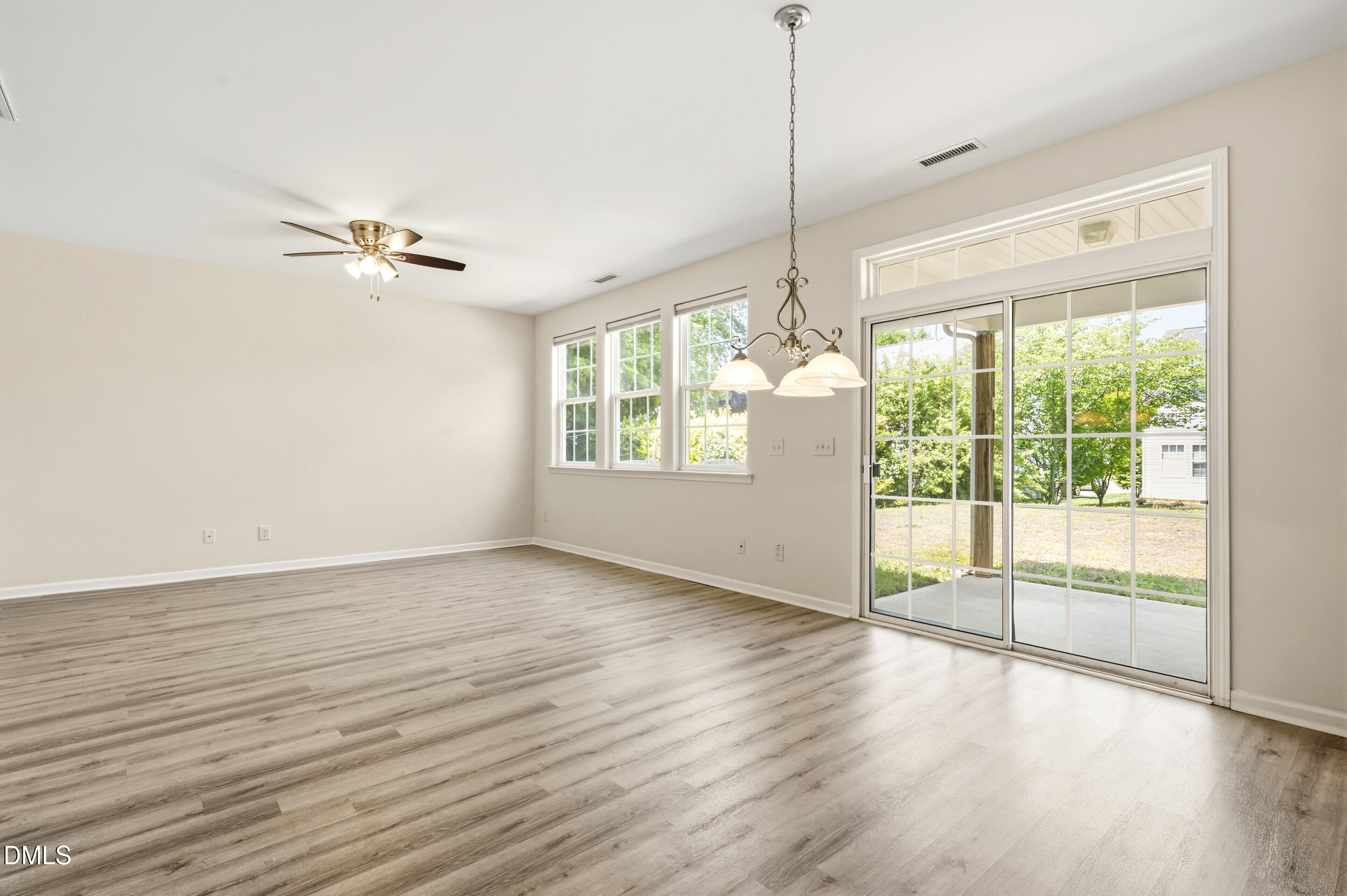 112 Ryder Cup Circle Raleigh, NC 27603 - Photo 7 of 45 a view of an empty room with a window and wooden floor