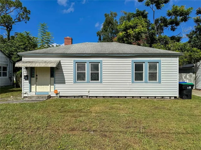 a house that has a tree in front of it