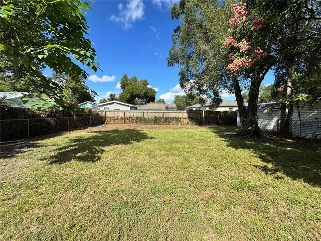 a view of a yard with swimming pool