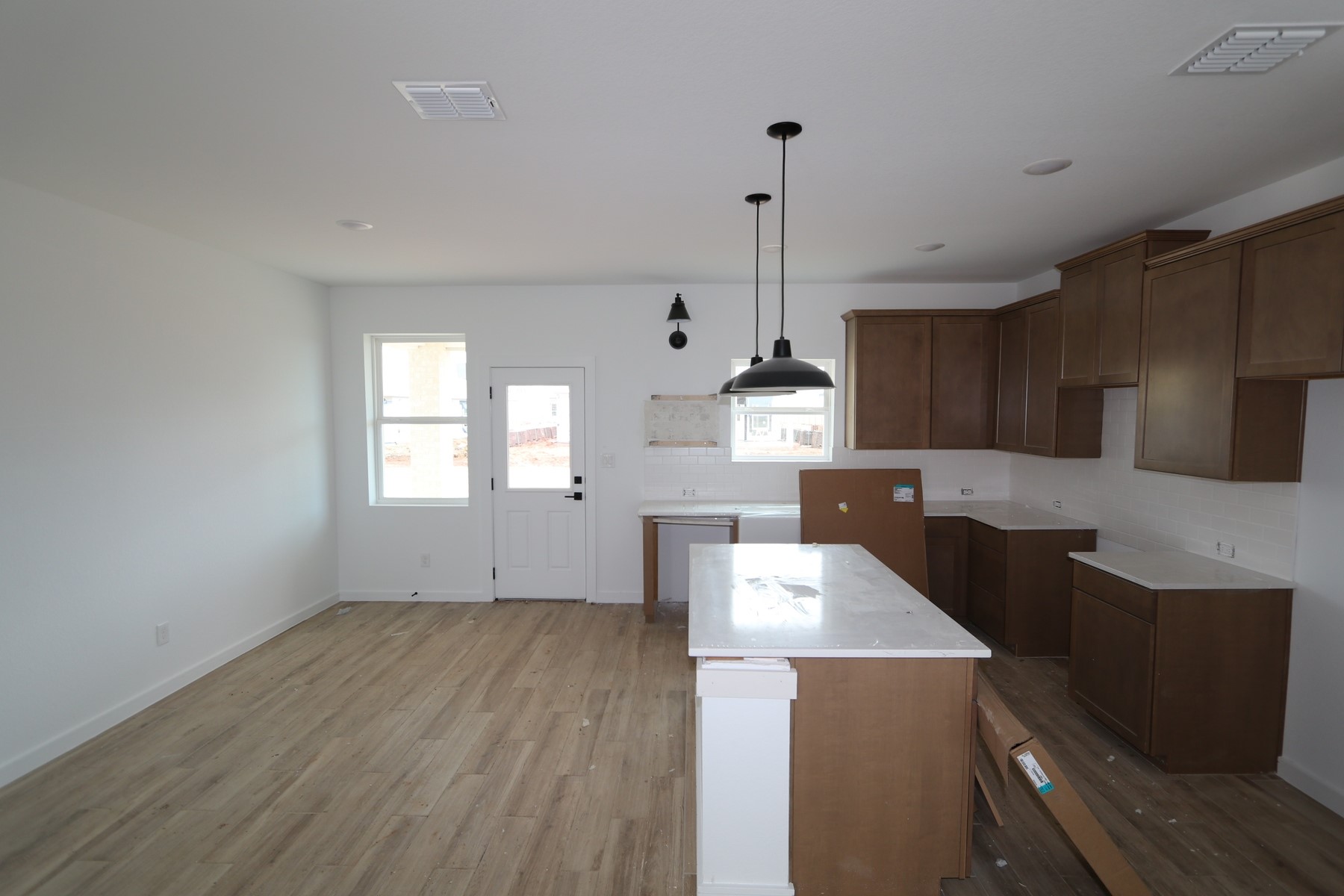 7923 Jade Crest Drive Angleton, TX 77515 - Photo 3 of 29 a kitchen with stainless steel appliances a stove a sink a refrigerator and white cabinets with wooden floor