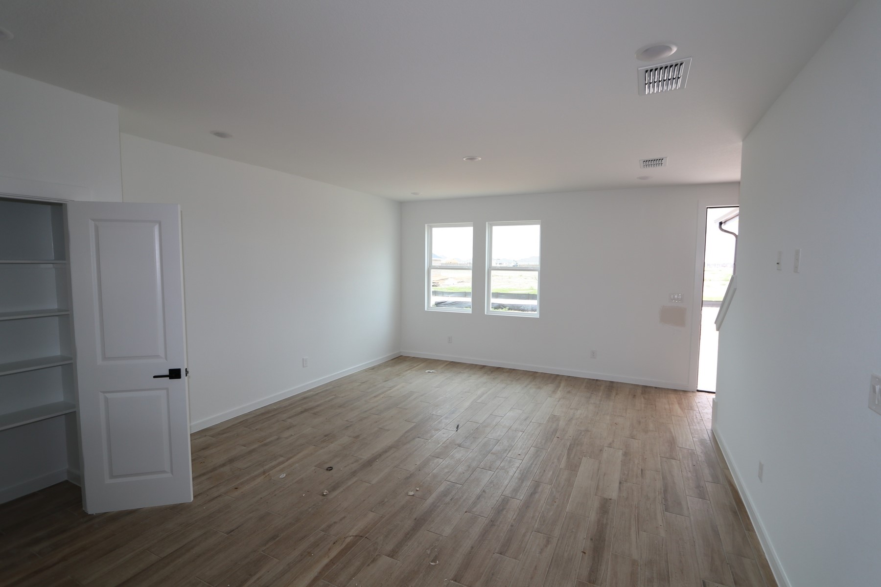 7923 Jade Crest Drive Angleton, TX 77515 - Photo 4 of 29 an empty room with wooden floor and window