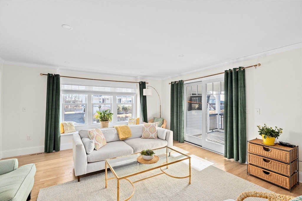 5 Vernon Avenue Hull, MA 02045 - Photo 11 of 33 a living room with furniture and a floor to ceiling window