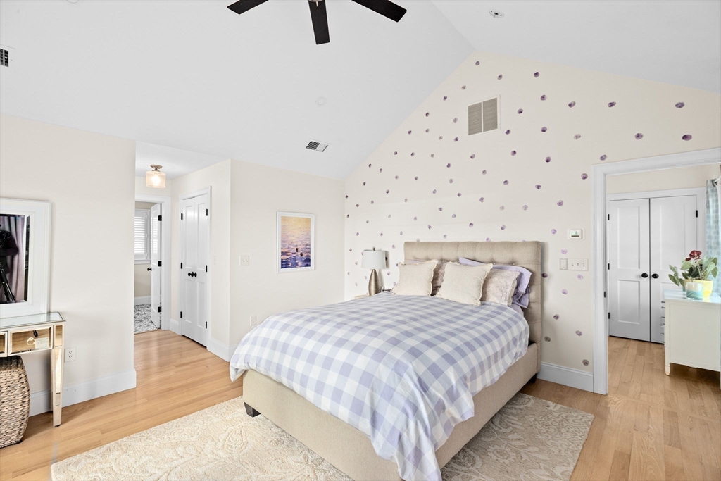 5 Vernon Avenue Hull, MA 02045 - Photo 17 of 33 a bedroom with a bed and a chandelier