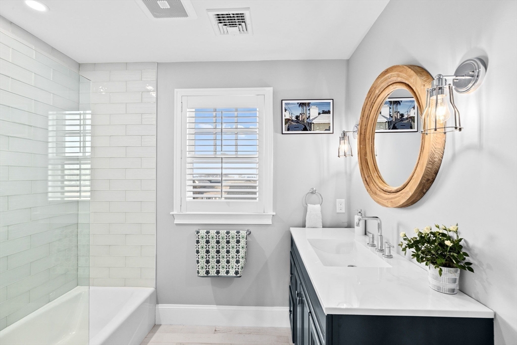 5 Vernon Avenue Hull, MA 02045 - Photo 22 of 33 a bathroom with a bathtub a sink and a mirror