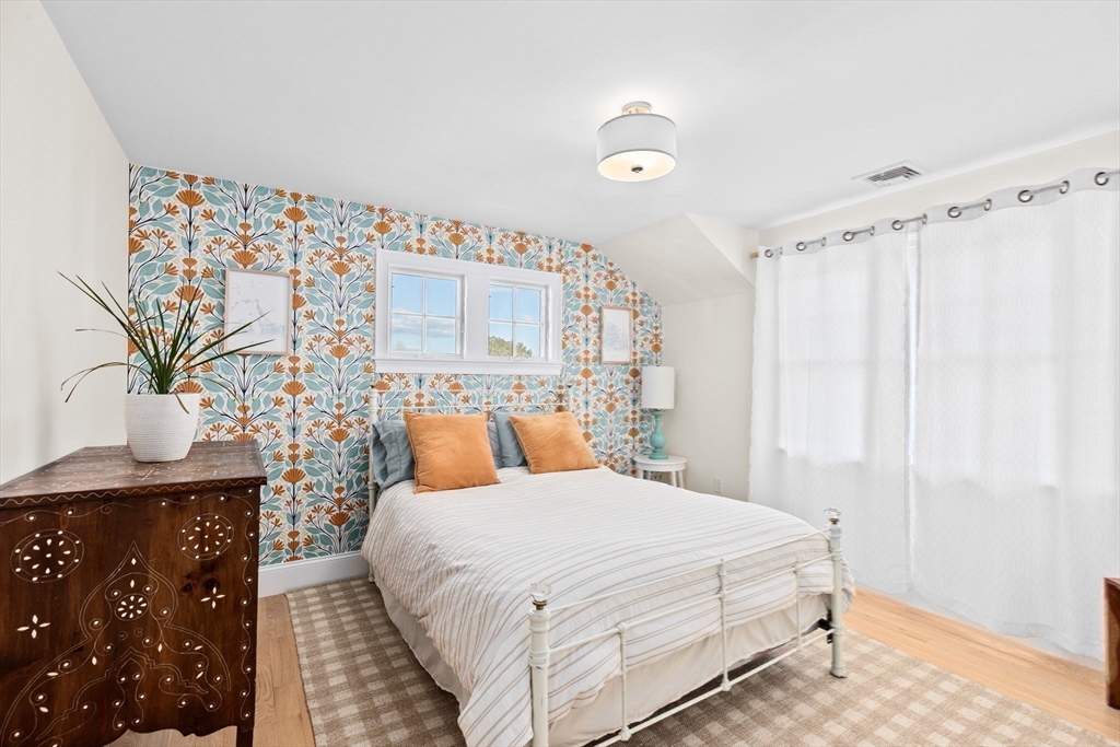 5 Vernon Avenue Hull, MA 02045 - Photo 24 of 33 a bedroom with a bed and a table