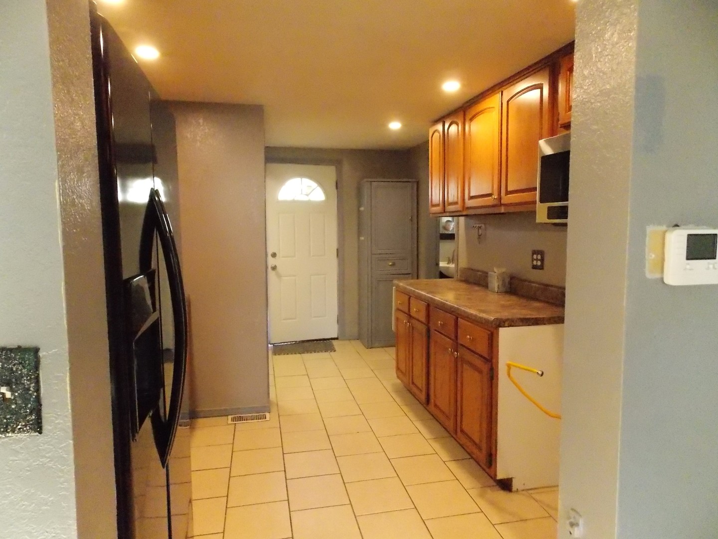 1648 Moonglow Road Centralia, IL 62801 - Photo 8 of 22 a large kitchen with stainless steel appliances a refrigerator and a stove top oven