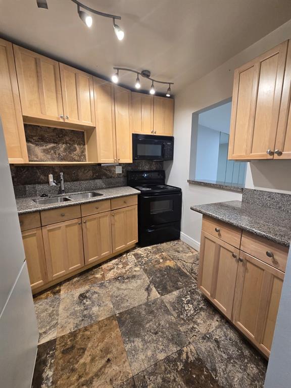 a kitchen with stainless steel appliances granite countertop a stove sink and cabinets