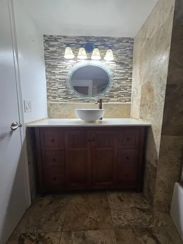 a bathroom with a sink and a mirror
