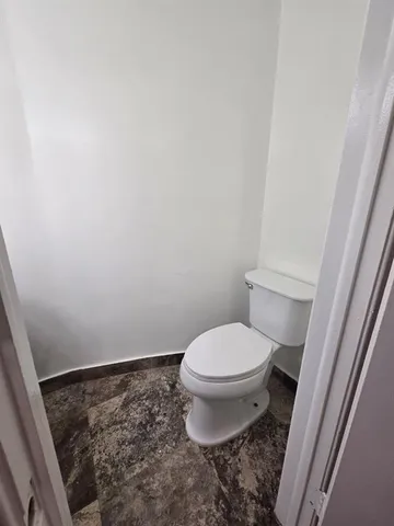 a bathroom with a toilet and a sink