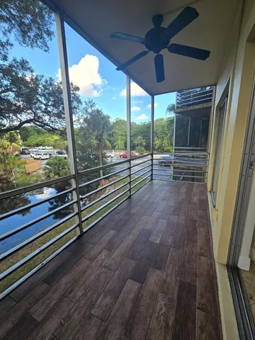 a view of a floor to ceiling window with wooden floor
