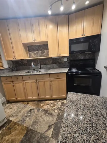 a kitchen with a stove a sink and a microwave