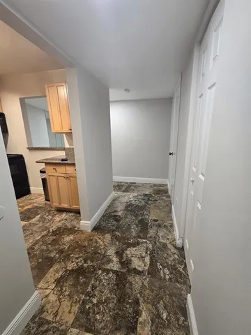 a view of a kitchen with wooden floor and electronic appliances