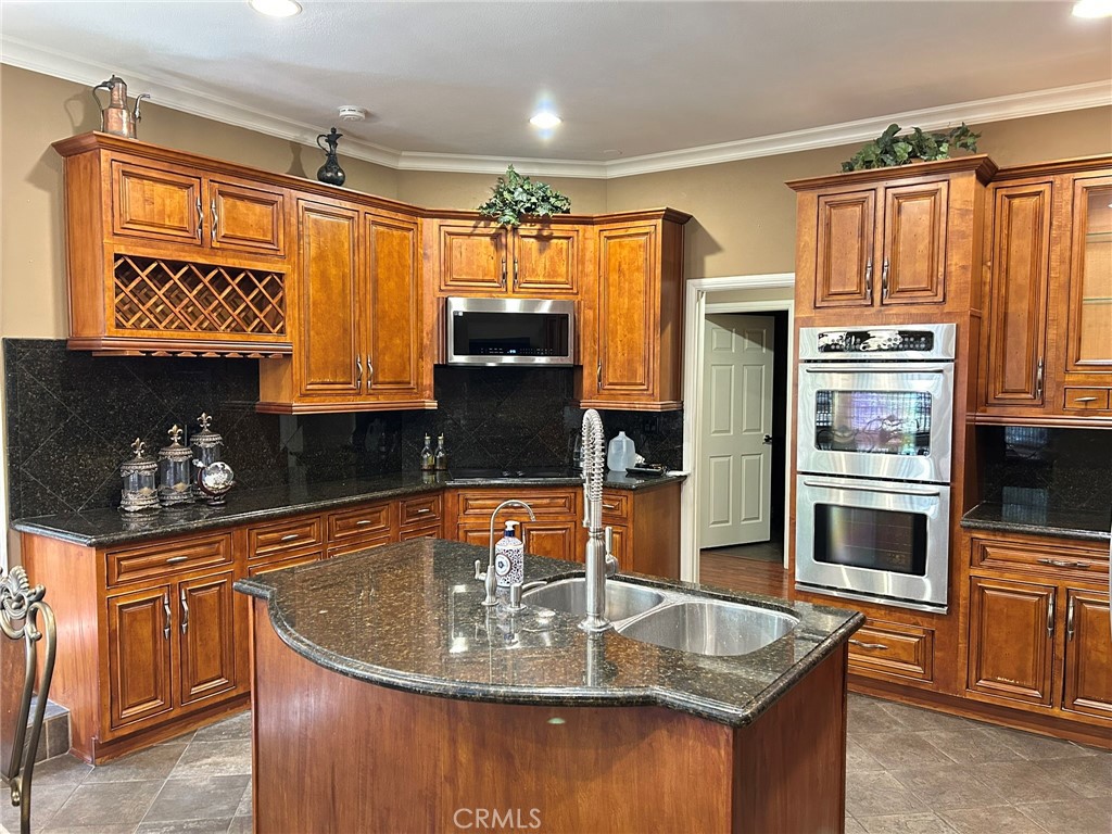 300 South Timken Road Anaheim, CA 92808 - Photo 15 of 40 a kitchen with stainless steel appliances granite countertop a sink a stove and a refrigerator