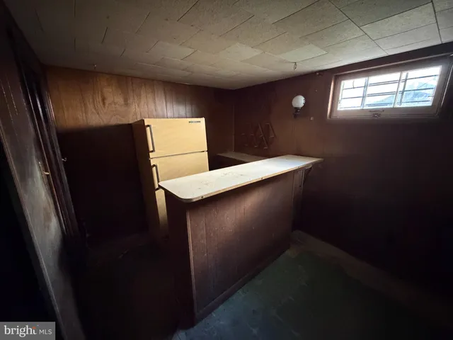 a kitchen with windows and refrigerator