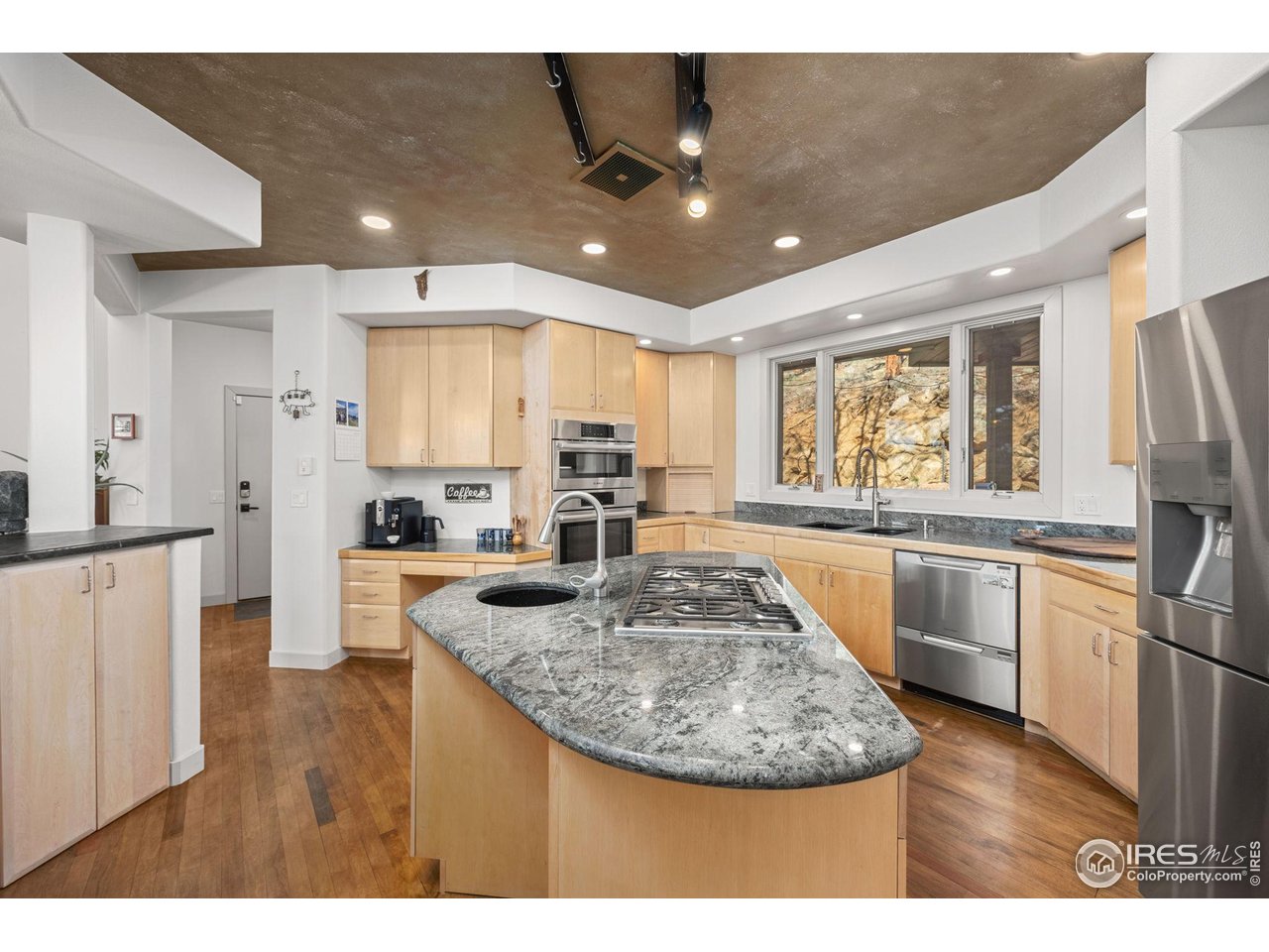 524 Cutter Lane Boulder, CO 80302 - Photo 18 of 49 a kitchen with stainless steel appliances granite countertop a sink refrigerator and cabinets