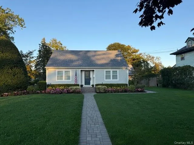 a front view of a house with a garden