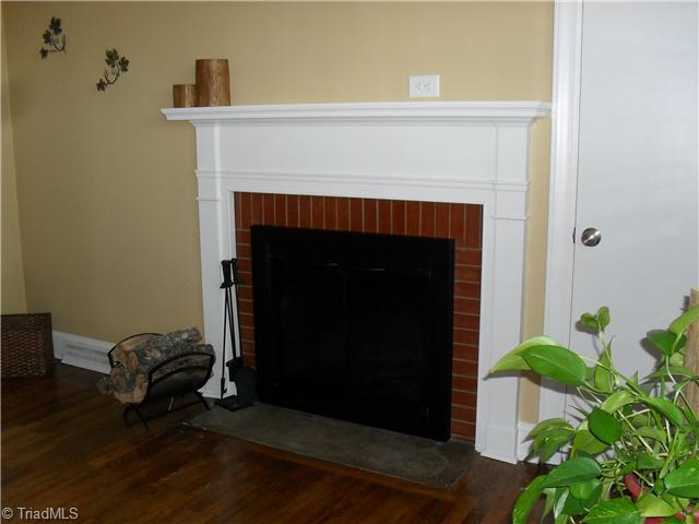 2457 Fairview Farm Road Asheboro, NC 27205 - Photo 2 of 15 Living Room. Enjoy setting in this Living Room with real wood burning fireplace, hard wood flooring, beautiful mantel, Crown molding and baseboard trim.