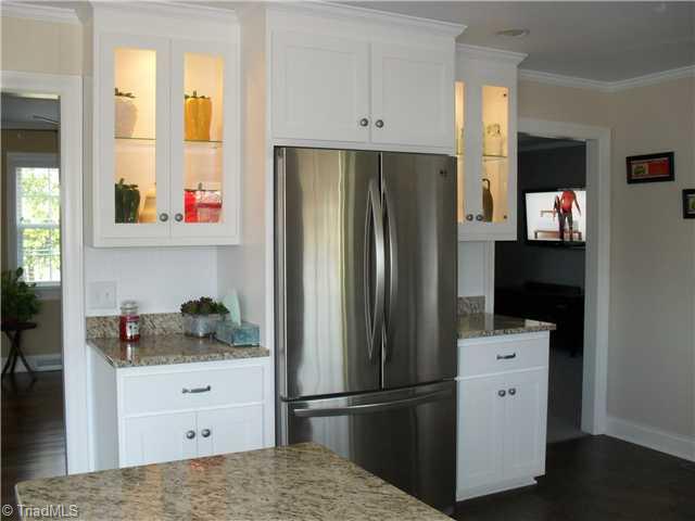 2457 Fairview Farm Road Asheboro, NC 27205 - Photo 5 of 15 Kitchen. Another view of the kitchen of the other side with lighting inside glass cabinets and Stainless steel refrigerator to remain.