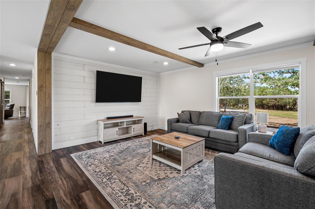 3050 Clater Powell Road Waco, TX 76705 - Photo 11 of 39 a living room with furniture and a flat screen tv