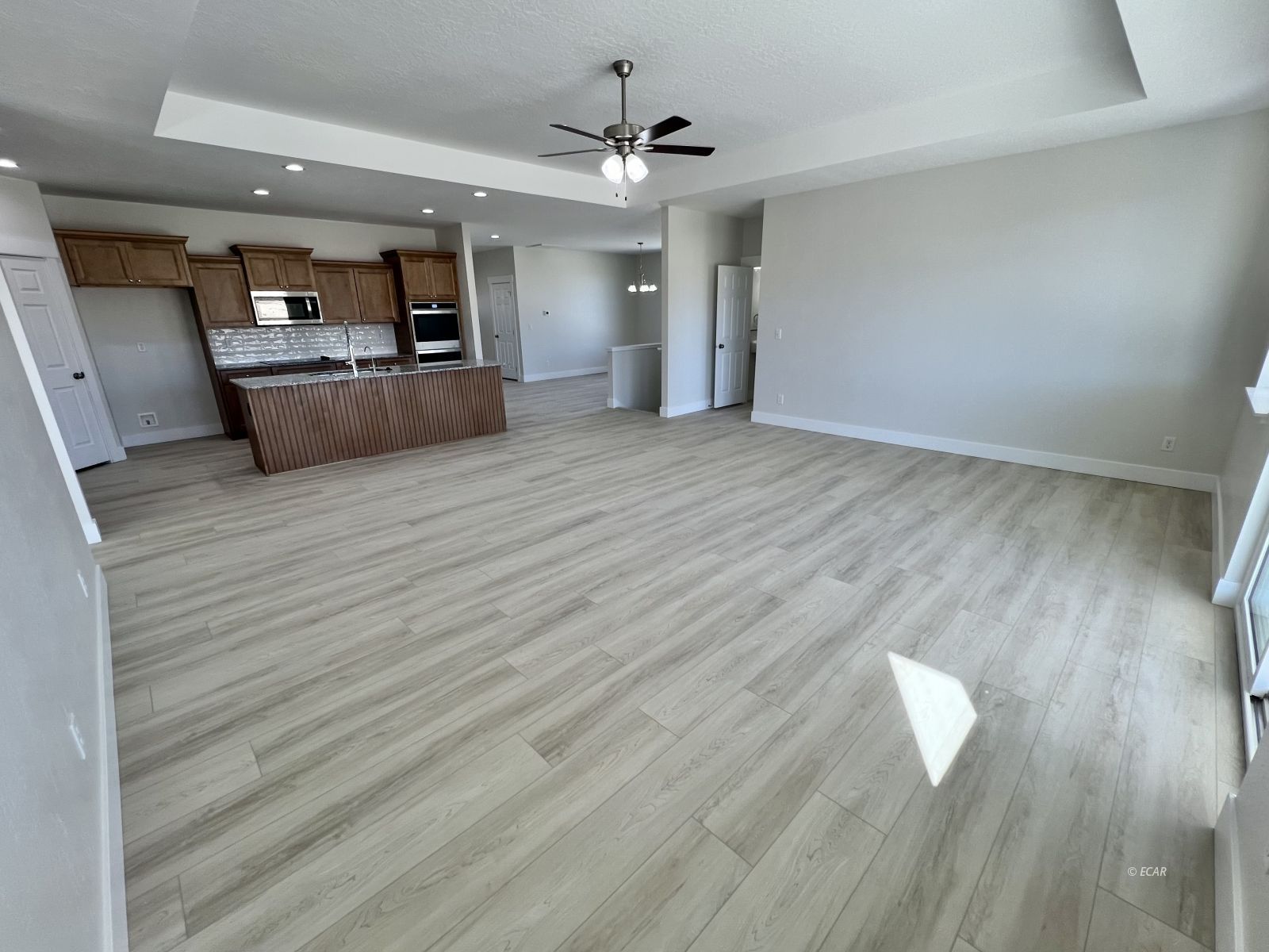 518 Ridgeway Drive Spring Creek, NV 89815 - Photo 11 of 37 wooden floor in an empty room with a kitchen