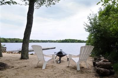 27 Nyes Point Way Centerville, MA 02632 - Photo 4 of 11 a lawn chairs sitting on a beach with a lake view