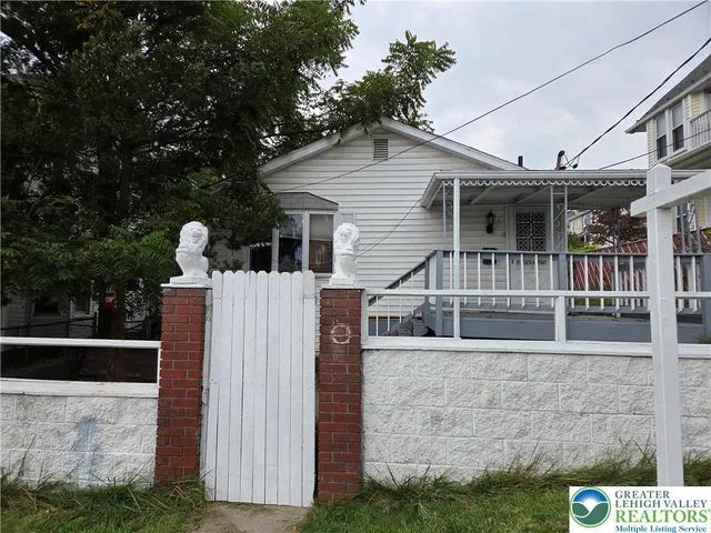 a view of house with a yard and seating space