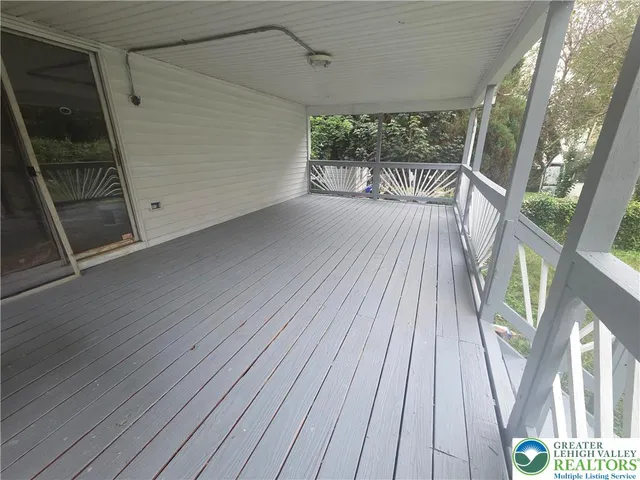 a view of balcony with wooden floor