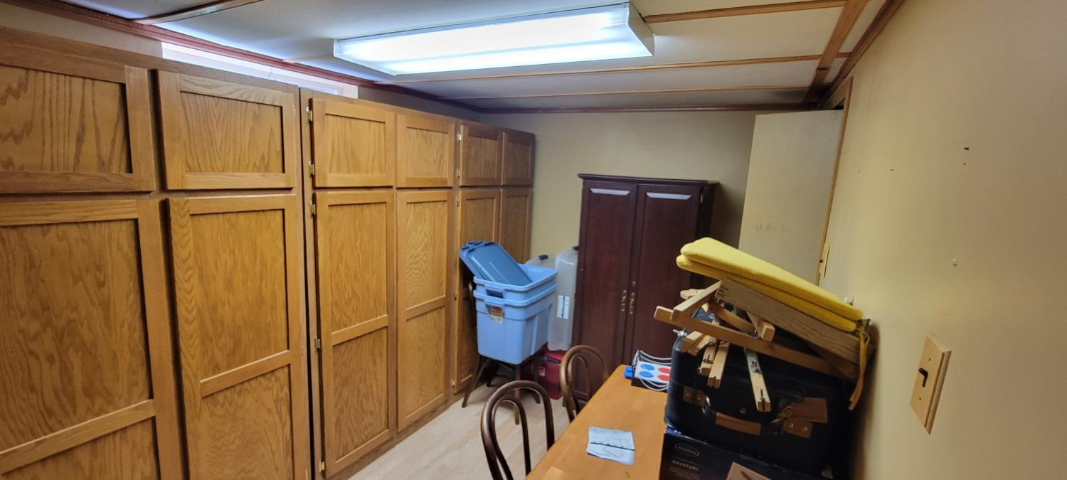 3402 North Wozniak Road Michigan City, IN 46360 - Photo 17 of 24 a view of storage and utility room with racks on the wall