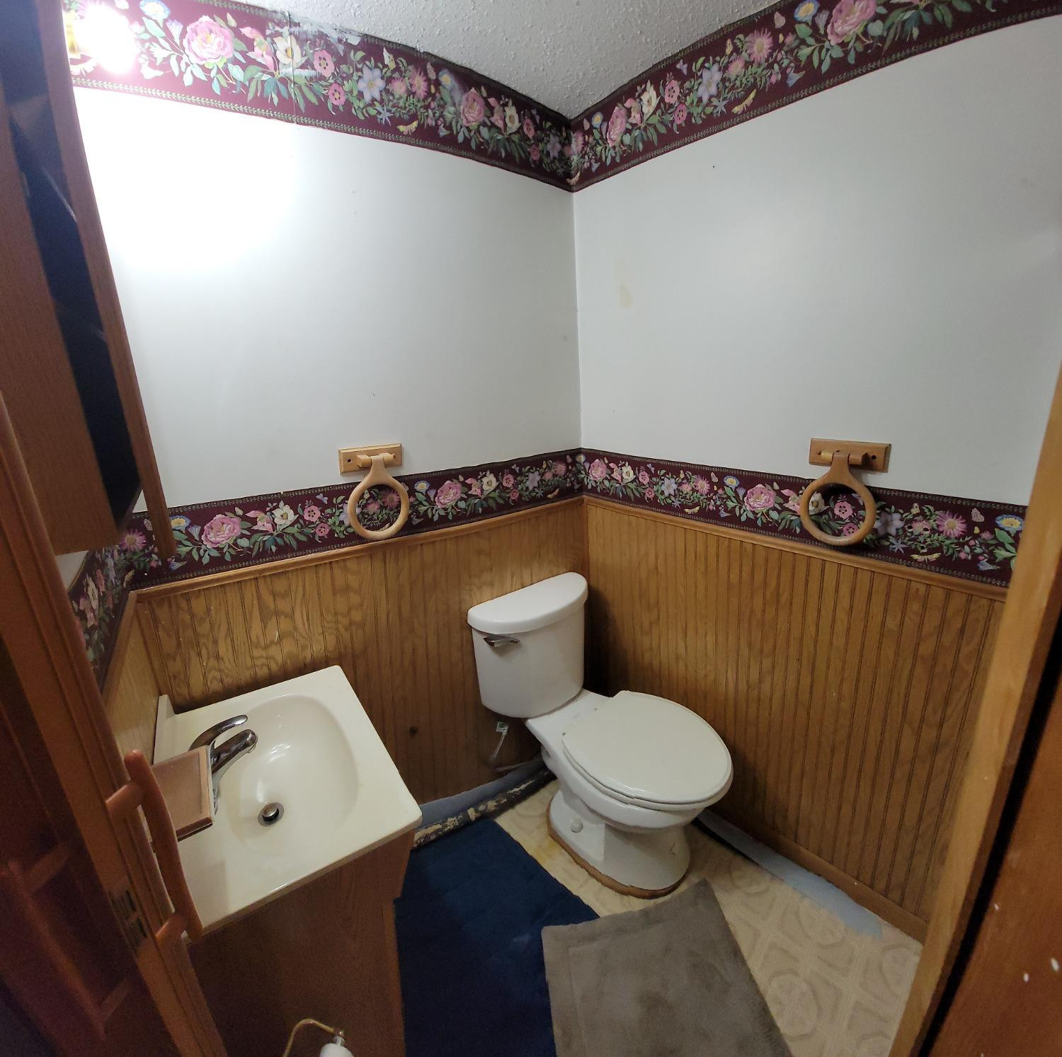 3402 North Wozniak Road Michigan City, IN 46360 - Photo 19 of 24 a bathroom with a toilet a sink and a mirror