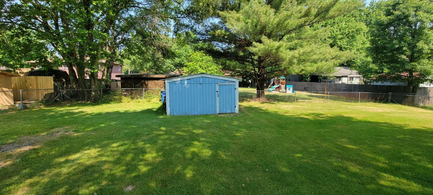 3402 North Wozniak Road Michigan City, IN 46360 - Photo 24 of 24 a backyard of a house with yard and tree