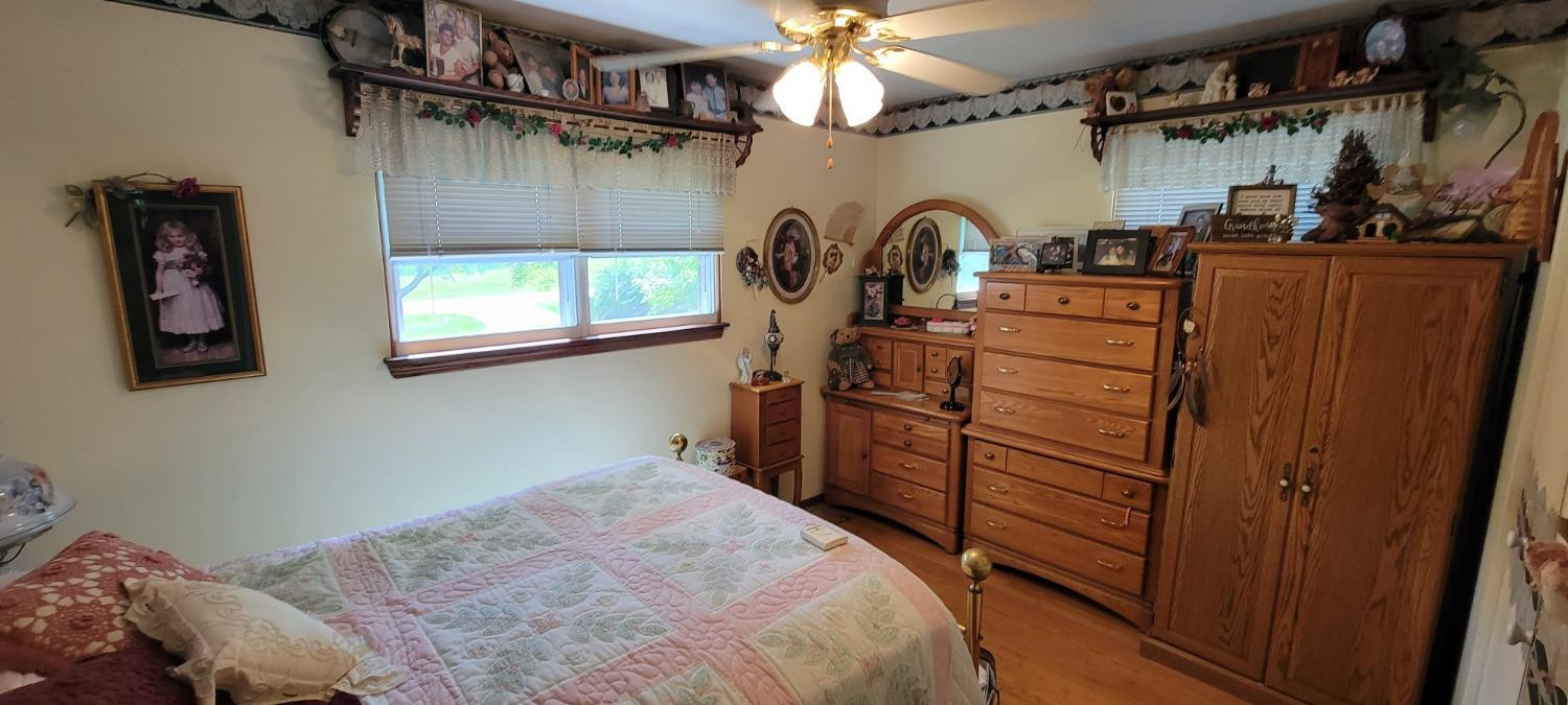 3402 North Wozniak Road Michigan City, IN 46360 - Photo 10 of 24 a bedroom with a bed and a flat tv screen on the dresser