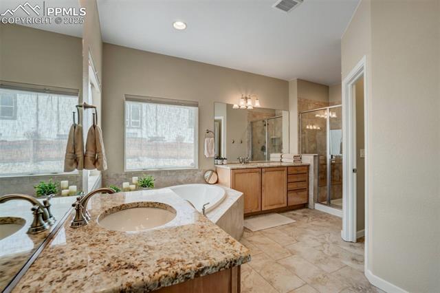 12442 Carmel Ridge Road Colorado Springs, CO 80921 - Photo 21 of 50 Bathroom with vanity and separate shower and tub