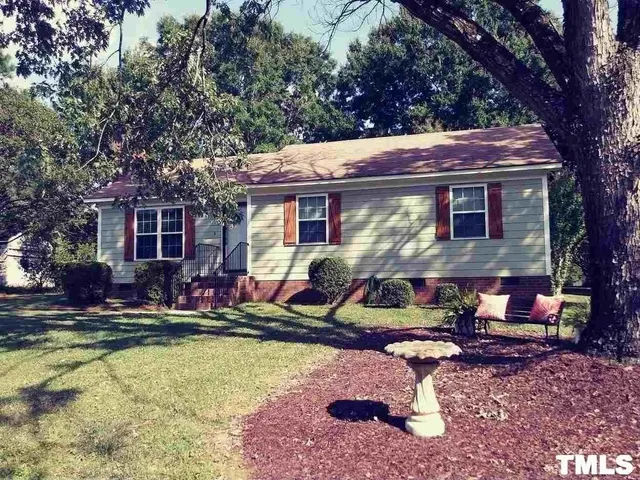 a view of house with swimming pool and chairs