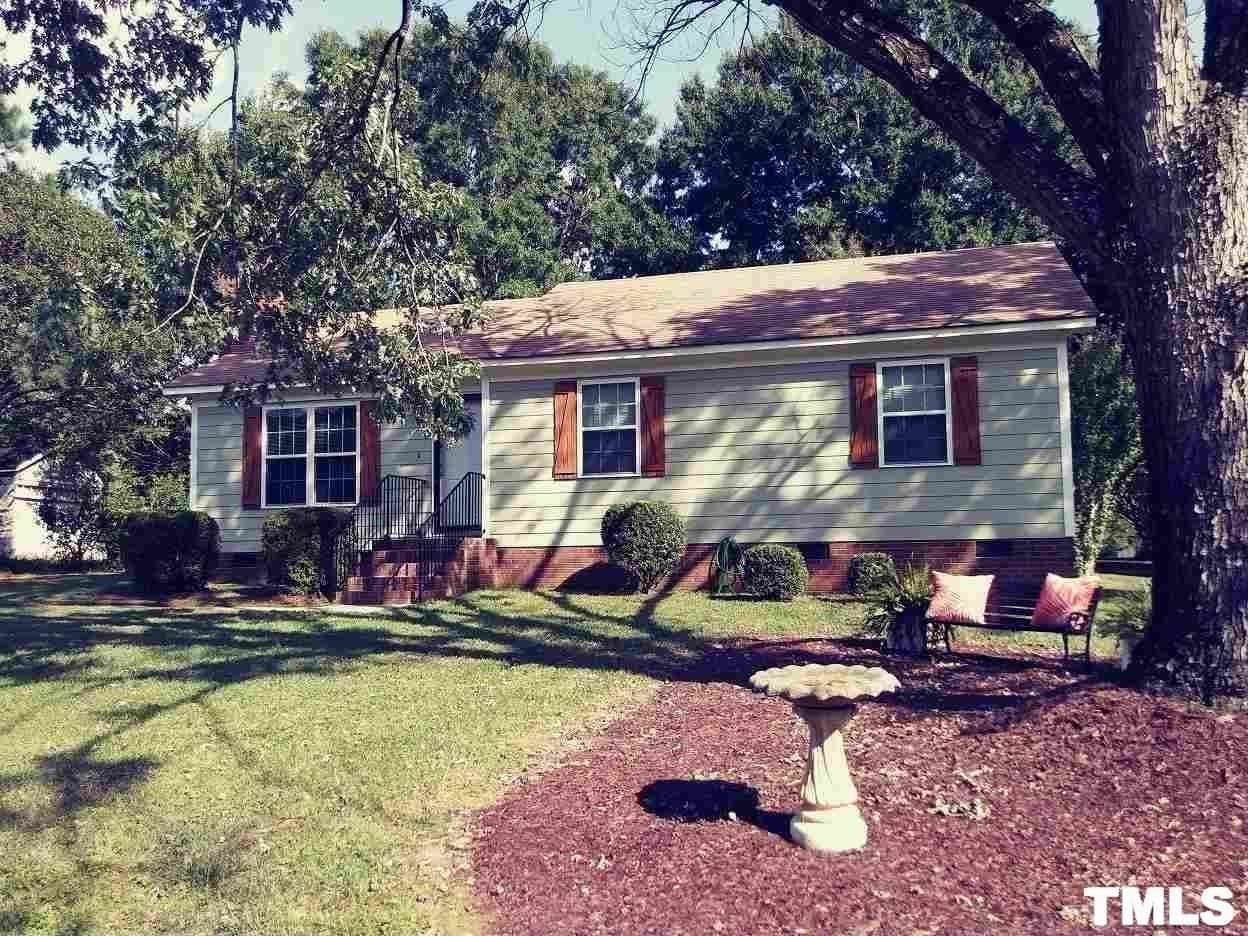 a view of house with swimming pool and chairs