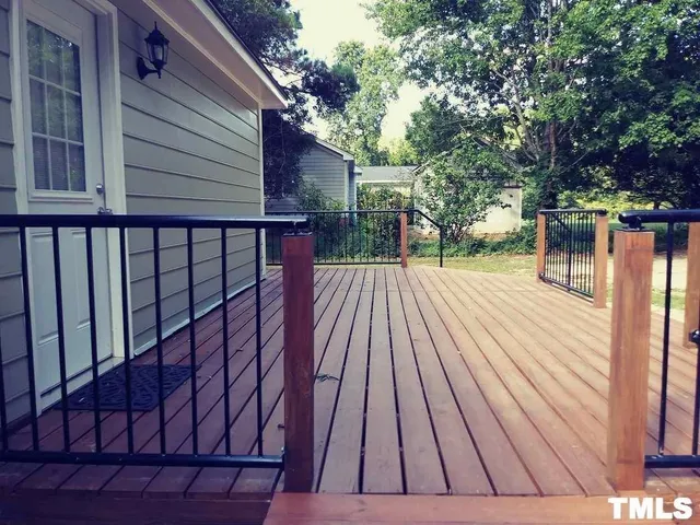 a view of backyard with a deck