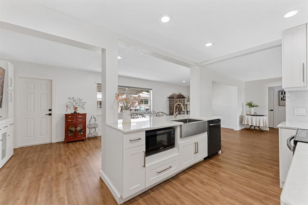 1001 Southwest 6th Avenue Boynton Beach, FL 33426 - Photo 11 of 31 a kitchen with stainless steel appliances a white stove top oven and a wooden floors